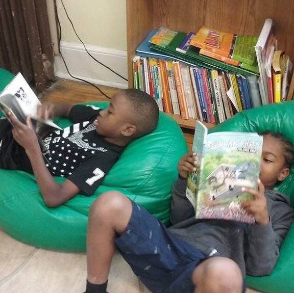 Children in after school program reading books